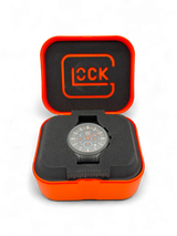 Original Glock Uhr Global mit orangem und schwarzem Mesh Band im orangen Glock Case